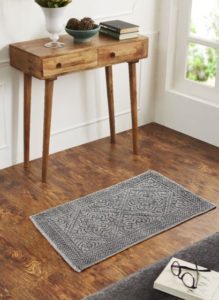 foyer area with small table area rug