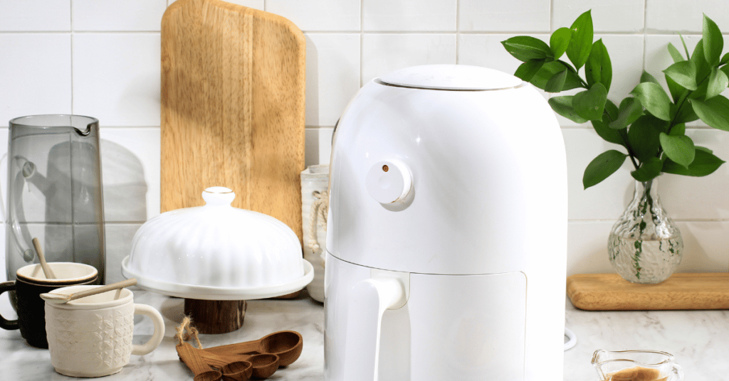 Air fryer in kitchen with coffee cups