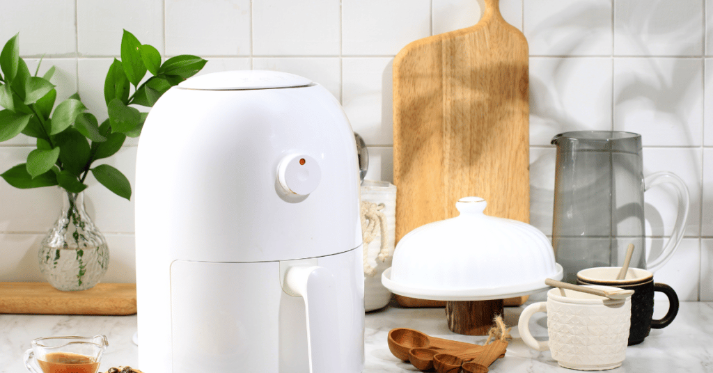 Air fryer with kitchenware and plant
