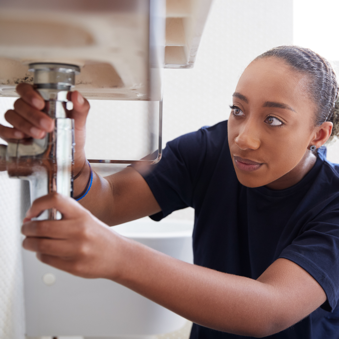 woman fixing leak